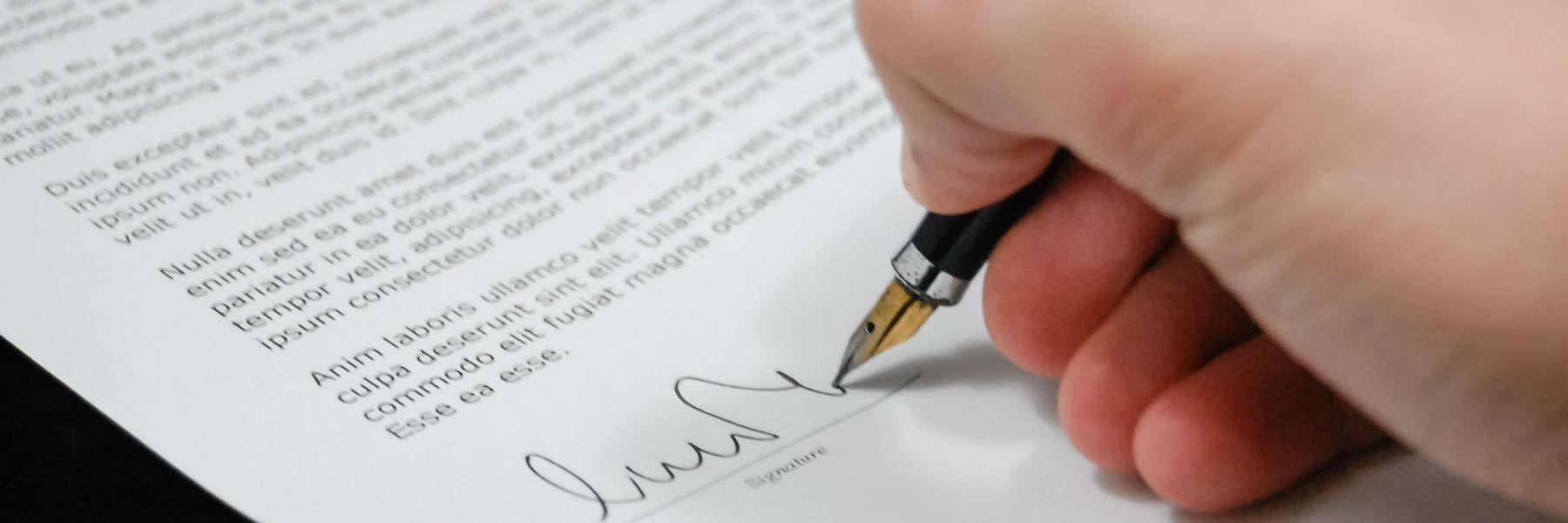 Person signing a legal document